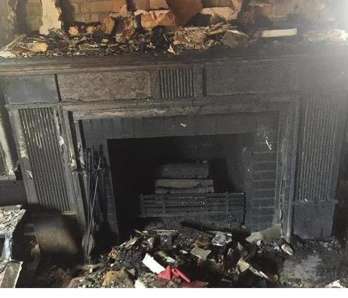 Fire Damaged fireplace mantel and debris